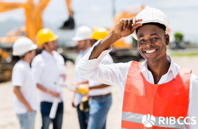 Construction worker in a white helmet and orange vest